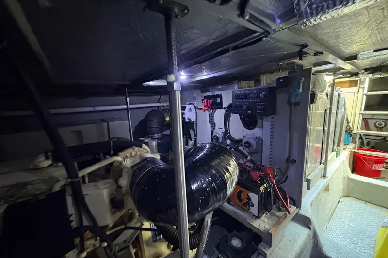 Slide: The Image of Engine room of 1999 Carver 530 Voyager Pilothouse with mechanical components and control panels. - 62