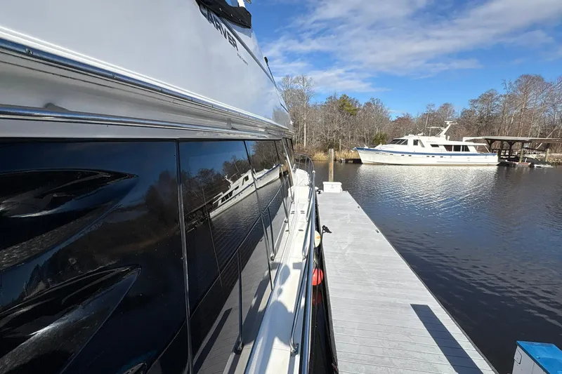 Slide: The Image of 1999 Carver 530 Voyager Pilothouse yacht docked on a sunny day. - 14