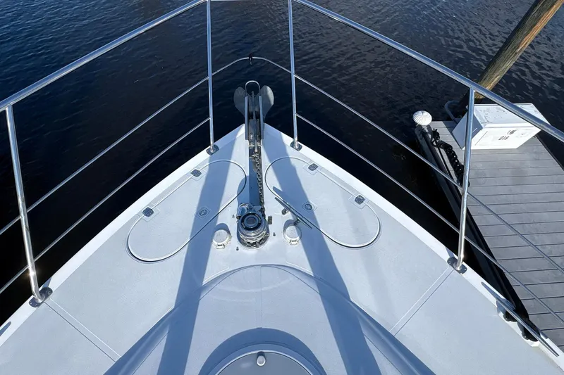 Slide: The Image of Bow of 1999 Carver 530 Voyager Pilothouse yacht at dock, featuring anchor and railing. - 17