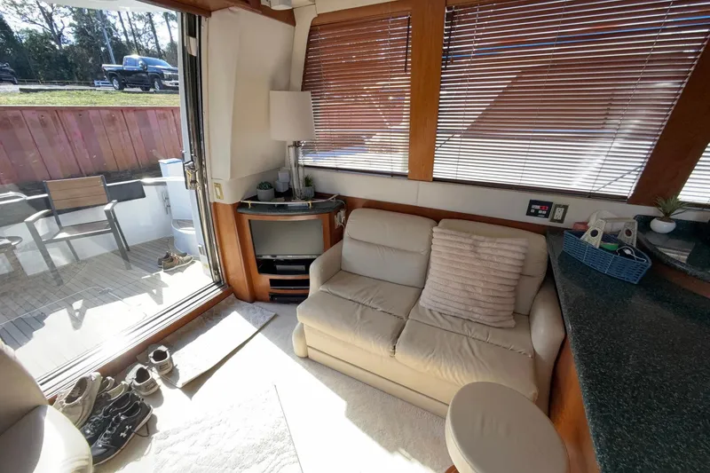 Slide: The Image of Interior of 1999 Carver 530 Voyager Pilothouse with cozy seating and natural light. - 21
