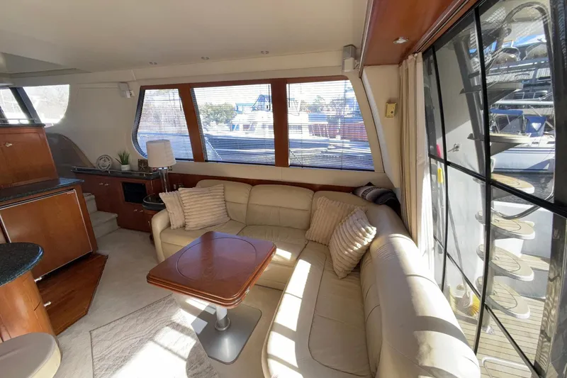 Slide: The Image of Luxurious interior of 1999 Carver 530 Voyager Pilothouse with plush seating and elegant wood finishes. - 24