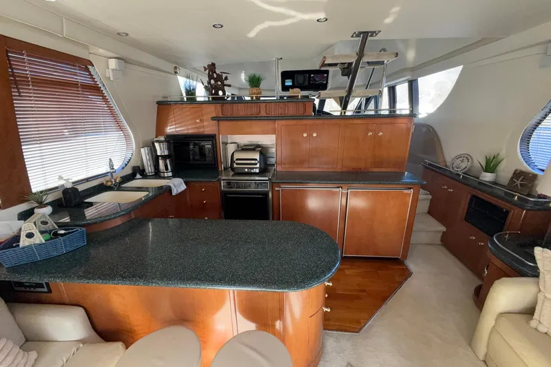Slide: The Image of Luxurious interior of a 1999 Carver 530 Voyager Pilothouse yacht with modern kitchen amenities. - 25