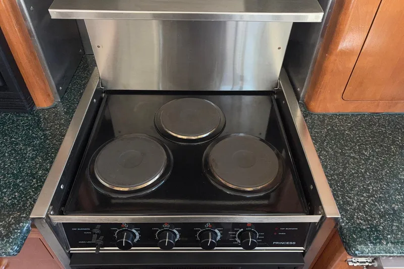 Slide: The Image of Electric stove with three burners in a 1999 Carver 530 Voyager Pilothouse kitchen. - 27