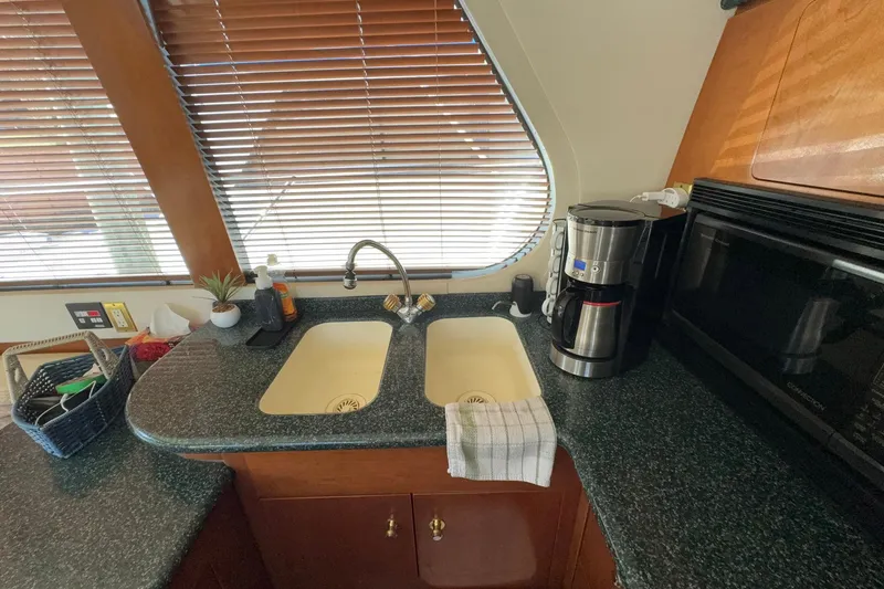 Slide: The Image of Kitchen area of 1999 Carver 530 Voyager Pilothouse with sink, coffee maker, and microwave. - 29