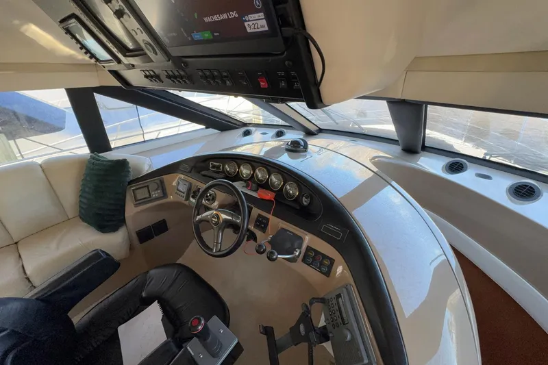 Slide: The Image of Interior of 1999 Carver 530 Voyager Pilothouse with steering wheel and control panel. - 34