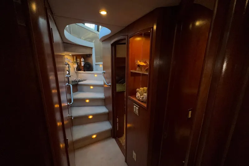 Slide: The Image of Interior of 1999 Carver 530 Voyager Pilothouse with illuminated stairs and wooden cabinetry. - 37