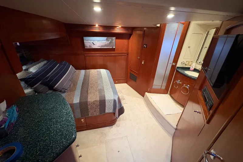 Slide: The Image of Luxurious interior of 1999 Carver 530 Voyager Pilothouse with cozy bedroom and ensuite bathroom. - 40
