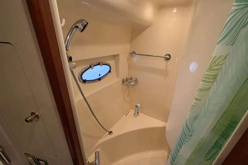 Slide: The Image of Shower area in 1999 Carver 530 Voyager Pilothouse with porthole and green curtain. - 43