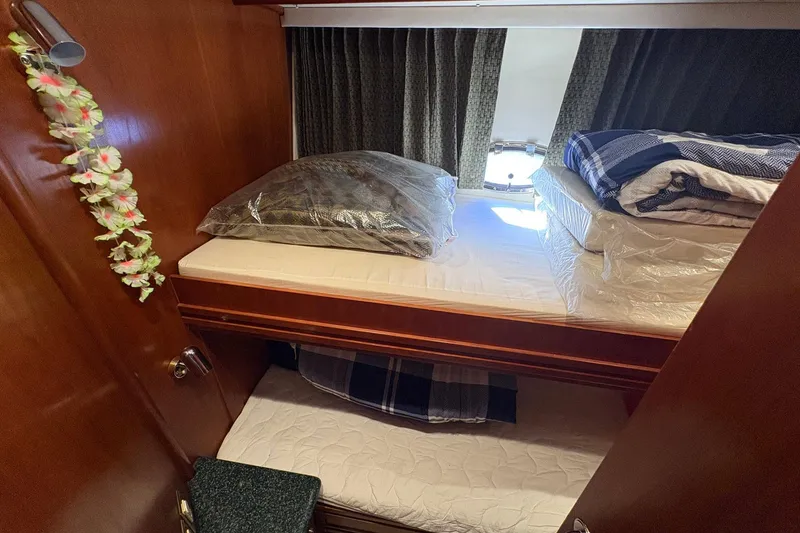 Slide: The Image of Cozy cabin interior of 1999 Carver 530 Voyager Pilothouse with bunk beds and decor. - 45