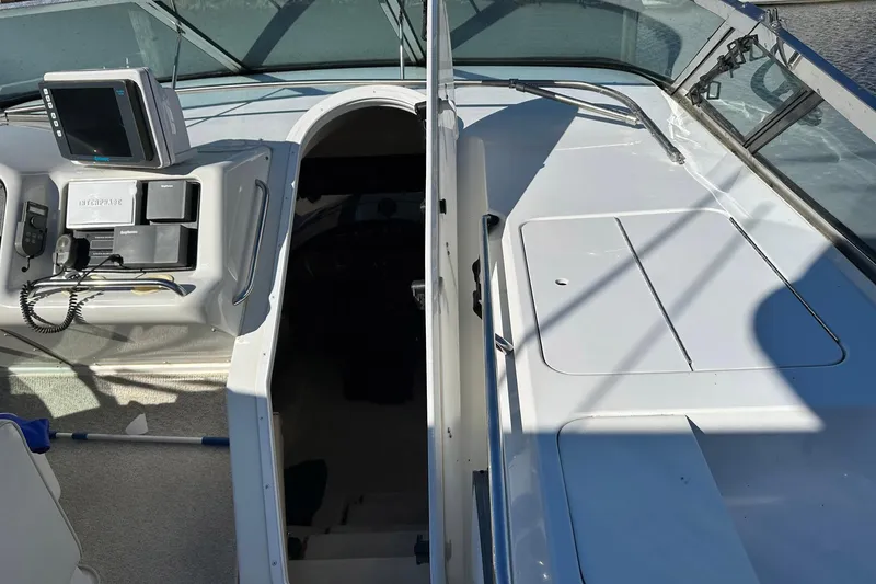 Slide: The Image of 1999 Carver 530 Voyager Pilothouse helm with navigation equipment and controls. - 51