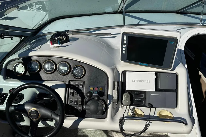 Slide: The Image of 1999 Carver 530 Voyager Pilothouse dashboard with steering wheel and navigation instruments. - 52