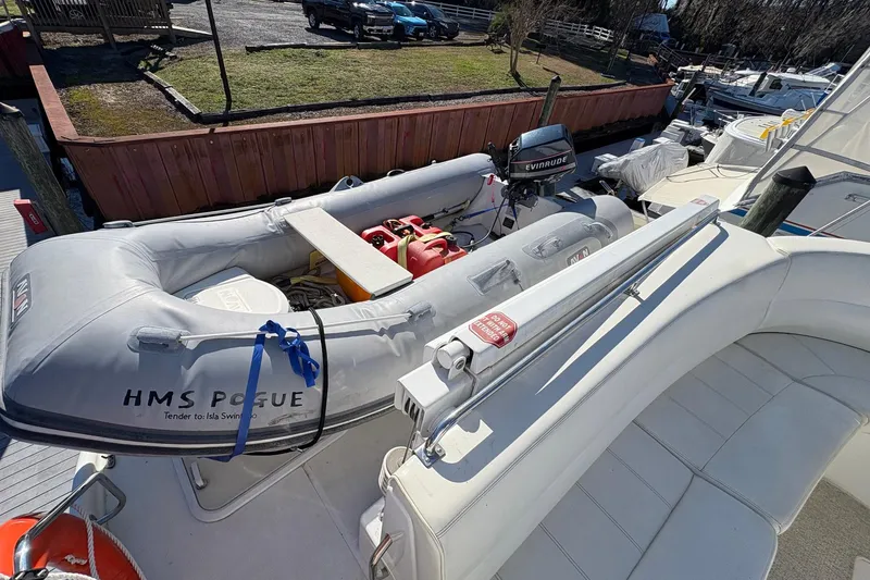 Slide: The Image of 1999 Carver 530 Voyager Pilothouse with inflatable tender and Evinrude motor on deck. - 55