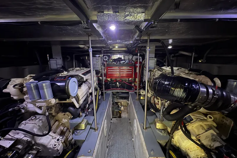 Slide: The Image of Engine room of 1999 Carver 530 Voyager Pilothouse with dual engines and equipment. - 58