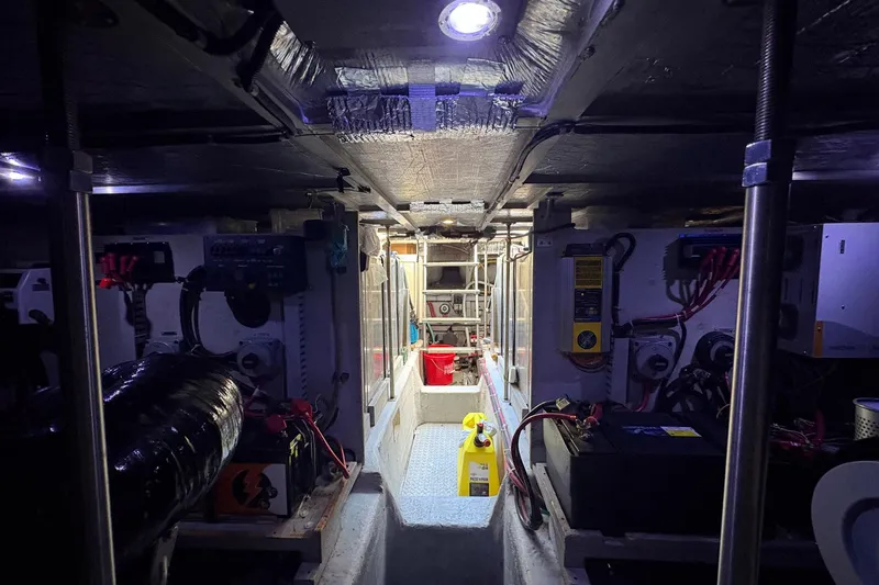 Slide: The Image of Engine room of a 1999 Carver 530 Voyager Pilothouse with visible machinery and equipment. - 63