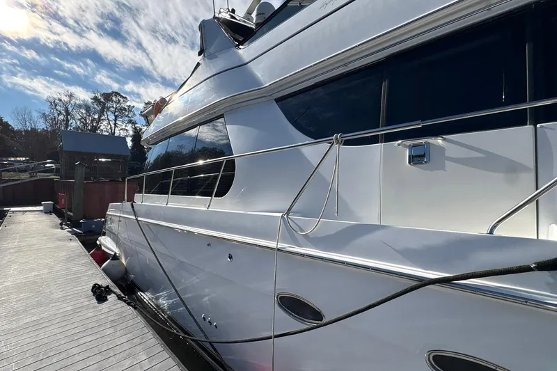 Slide: The Image of 1999 Carver 530 Voyager Pilothouse yacht docked under a sunny sky. - 9