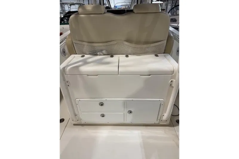 Slide: The Image of 2015 Cobia 296 Center Console boat interior with storage compartments and seating. - 12