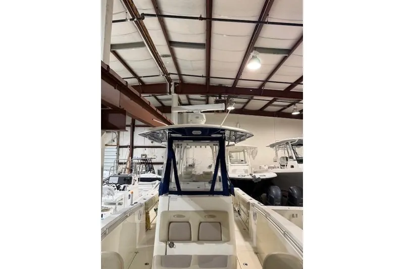 Slide: The Image of 2015 Cobia 296 Center Console boat in indoor storage facility. - 6