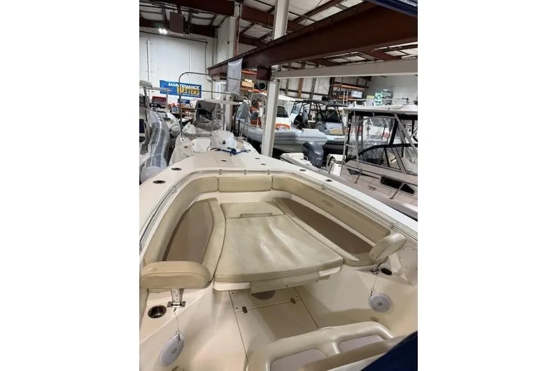 Slide: The Image of 2015 Cobia 296 Center Console boat interior in a showroom. - 7