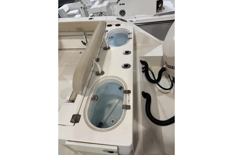 Slide: The Image of 2015 Cobia 296 Center Console boat with livewell and seating area. - 9