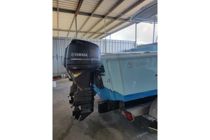 Slide: The Image of 1996 Edgewater 210 Inshore boat with Yamaha outboard motor in covered storage. - 2