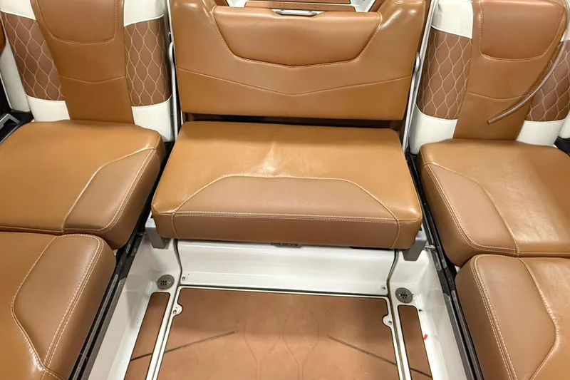 Slide: The Image of Luxurious brown leather seating in 2022 Malibu M220 boat interior. - 13