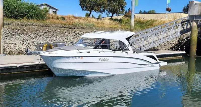 The Image of 2021 Beneteau Antares 8 docked at a marina, side view. - 0