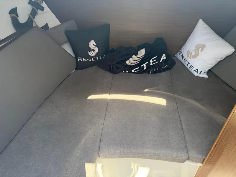Slide: The Image of Interior cabin of 2021 Beneteau Antares 8 with branded cushions and anchor decor. - 23