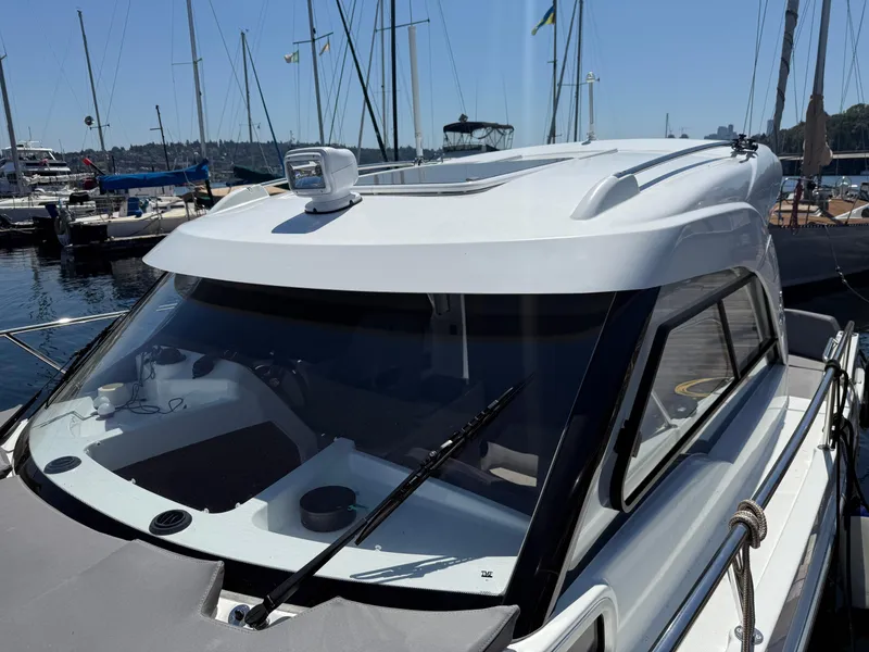 Slide: The Image of 2021 Beneteau Antares 8 boat docked in marina, showcasing sleek design and modern features. - 31