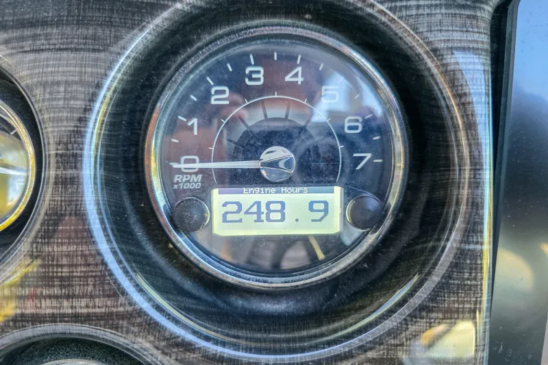 Slide: The Image of Steering console of 2022 Monterey 295 Sport Yacht with navigation display and controls. - 12