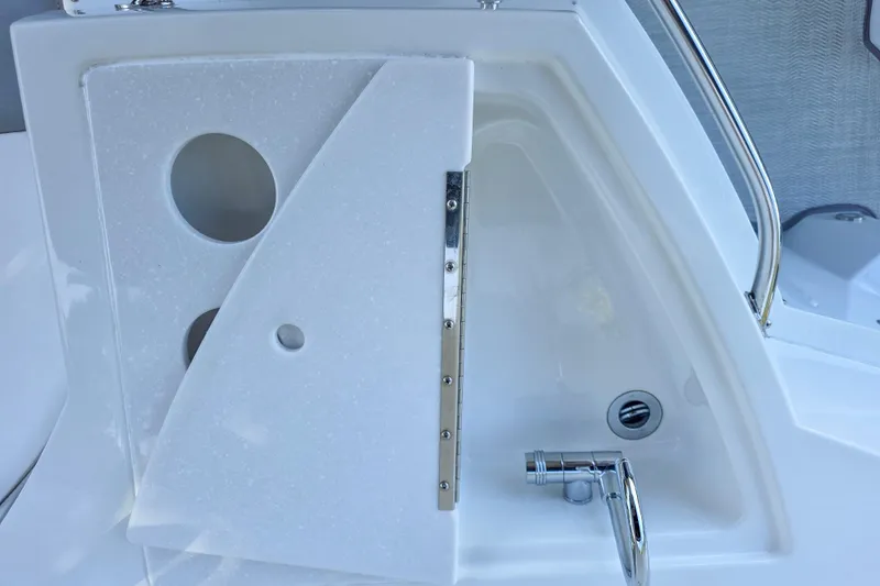 Slide: The Image of 2022 Monterey 295 Sport Yacht interior with seating, helm, and cabin entrance. - 15