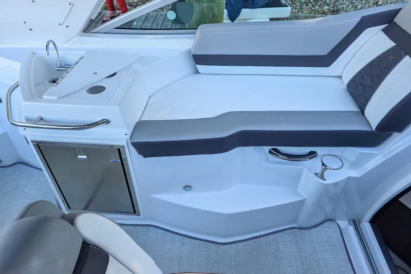 Slide: The Image of 2022 Monterey 295 Sport Yacht with elegant seating and swim platform on calm water. - 18