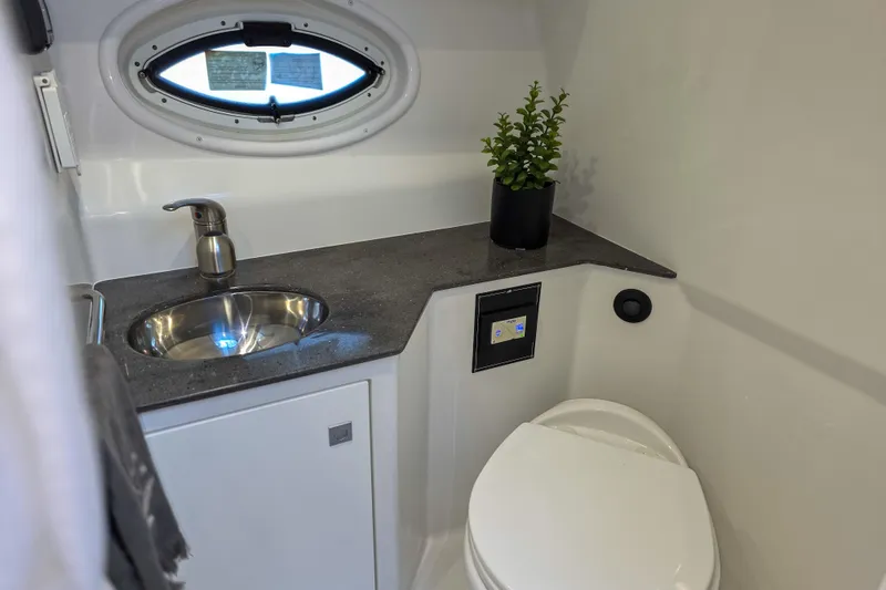 Slide: The Image of Interior of 2022 Monterey 295 Sport Yacht featuring modern kitchen and seating area. - 5