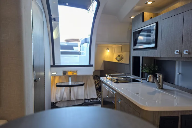 Slide: The Image of Control panel of 2022 Monterey 295 Sport Yacht with stereo and electrical switches. - 6