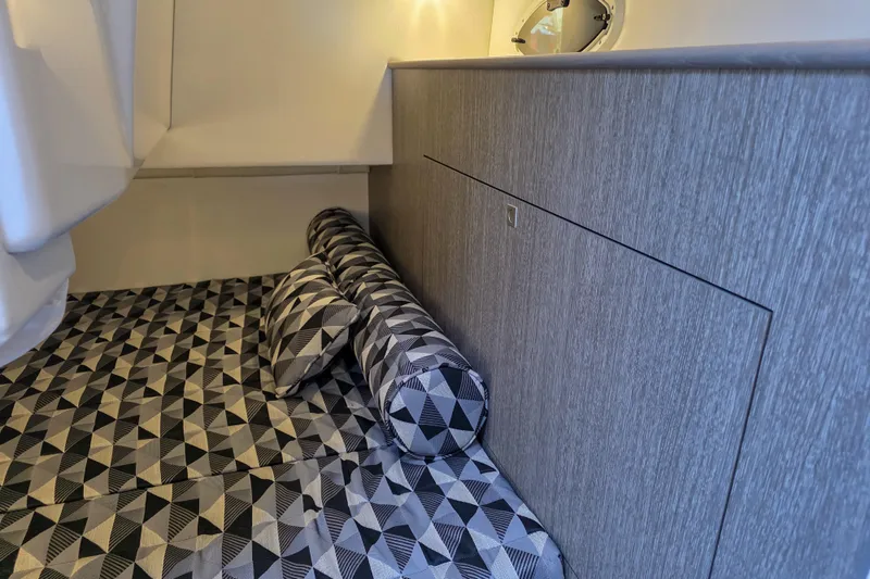 Slide: The Image of 2022 Monterey 295 Sport Yacht interior with kitchenette, seating, and ambient lighting. - 8