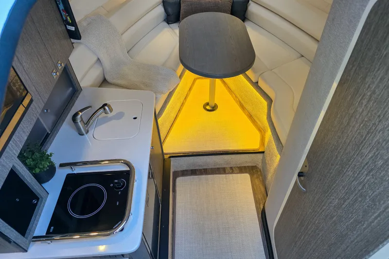 Slide: The Image of 2022 Monterey 295 Sport Yacht bow view at dock, featuring sleek design and railing. - 9