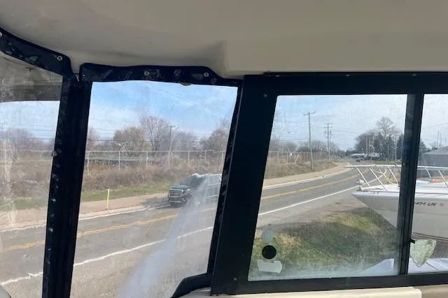 Slide: The Image of View from inside a 2004 Bayliner 242 Classic boat, showing road and landscape. - 12