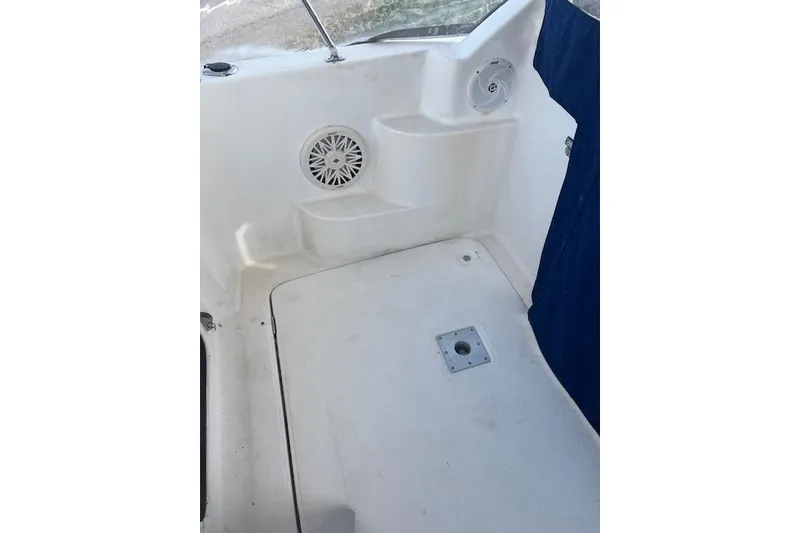 Slide: The Image of 2004 Bayliner 242 Classic boat interior with speaker and step detail. - 13