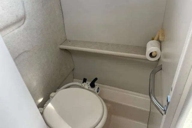 Slide: The Image of 2004 Bayliner 242 Classic boat bathroom with toilet and toilet paper holder. - 16