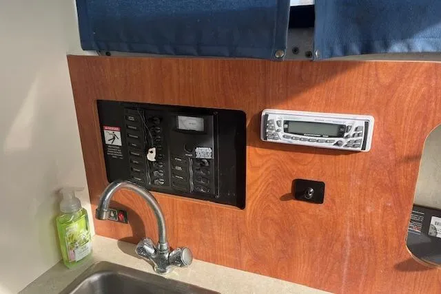 Slide: The Image of Control panel and sink area inside a 2004 Bayliner 242 Classic boat. - 17