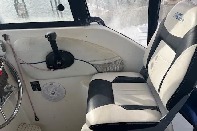 Slide: The Image of Interior of 2004 Bayliner 242 Classic boat with steering wheel and seat. - 8