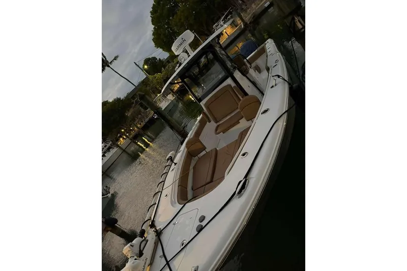 Slide: The Image of 2021 Sea Hunt Gamefish 30 boat with forward seating, docked at a marina. - 10