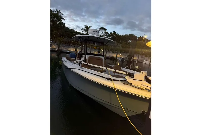Slide: The Image of 2021 Sea Hunt Gamefish 30 boat docked at sunset with Garmin equipment. - 13