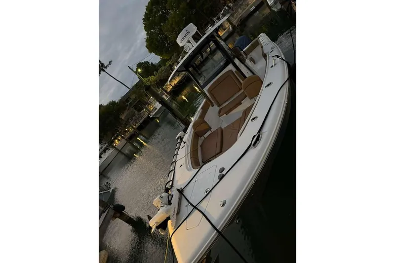 Slide: The Image of 2021 Sea Hunt Gamefish 30 boat docked, featuring forward seating and sleek design. - 16