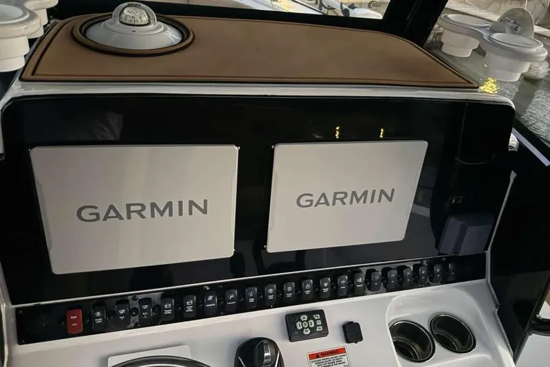 Slide: The Image of 2021 Sea Hunt Gamefish 30 dashboard with dual Garmin displays and controls. - 18