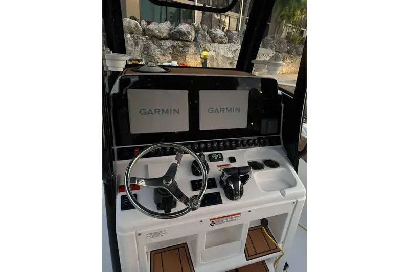 Slide: The Image of 2021 Sea Hunt Gamefish 30 helm with dual Garmin displays and modern controls. - 19