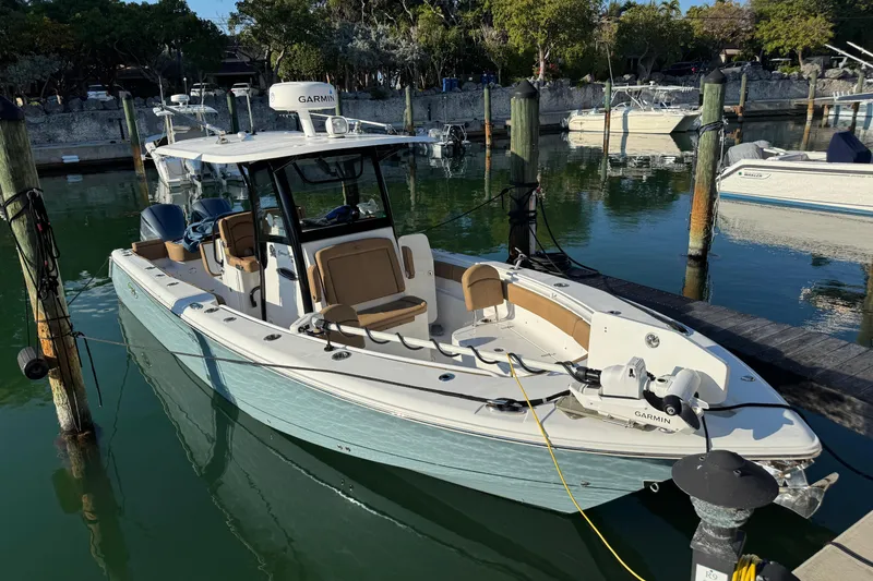Slide: The Image of 2021 Sea Hunt Gamefish 30 boat docked in a marina, featuring forward seating. - 2