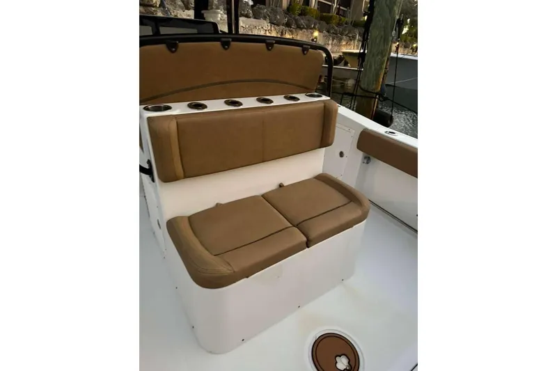 Slide: The Image of 2021 Sea Hunt Gamefish 30 boat with tan forward seating and cup holders. - 21