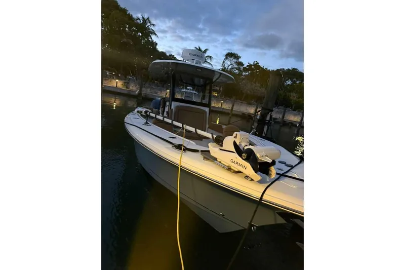 Slide: The Image of 2021 Sea Hunt Gamefish 30 boat docked at twilight with Garmin equipment. - 23