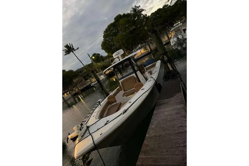Slide: The Image of 2021 Sea Hunt Gamefish 30 Forward Seating boat docked at sunset. - 26