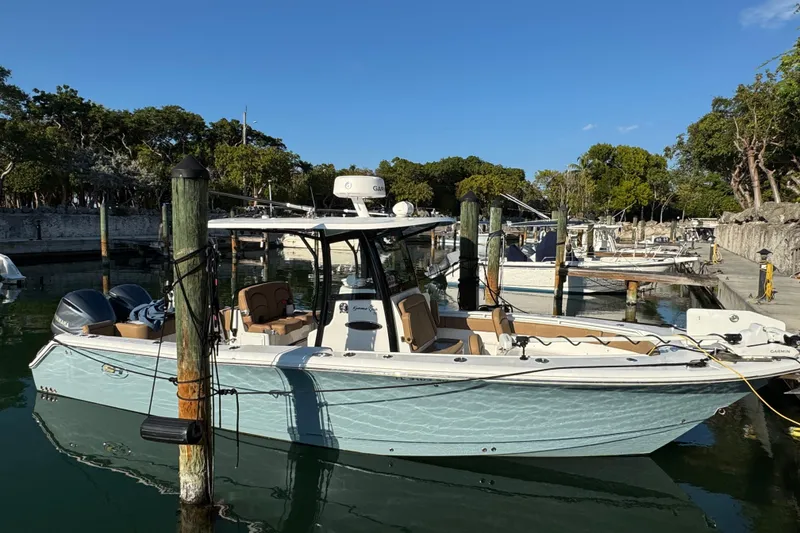 Slide: The Image of 2021 Sea Hunt Gamefish 30 boat docked in a serene marina setting. - 4